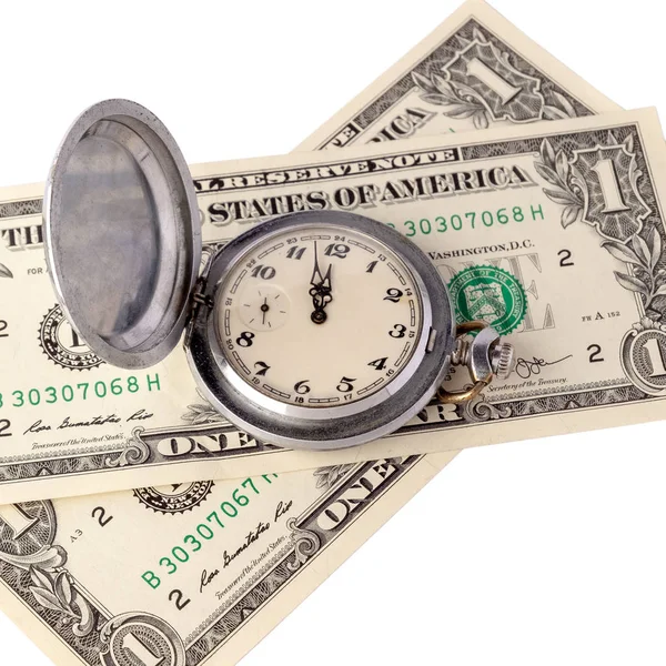 Close-up of a retro pocket watch on two bills of one US dollar. The arrows indicate midday or midnight. The concept on the time management or advertising watchshop. Isolated on white background.