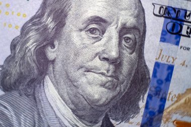 Makro. Benjamin Franklin bir portre yüz doları bize bill. Mavi koruyucu şerit. Seçici odak. Yakın çekim.