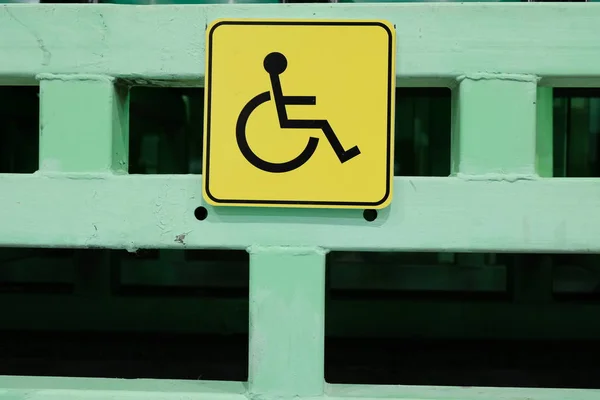 Protection and assistance for people with disabilities. Yellow sign is a place for disabled people. Social sphere of life.