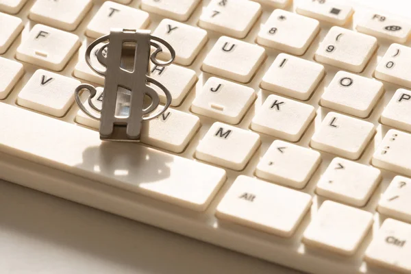 Le symbole du dollar américain se trouve sur un clavier blanc pour un ordinateur. Gros plan. Contexte de la conception sur le thème de la technologie de l'information financière . — Photo