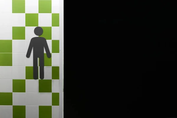 Restroom. Symbols of man on the wall with green and white squares. Public place. Copyspace. Black freespace. — Stock Photo, Image