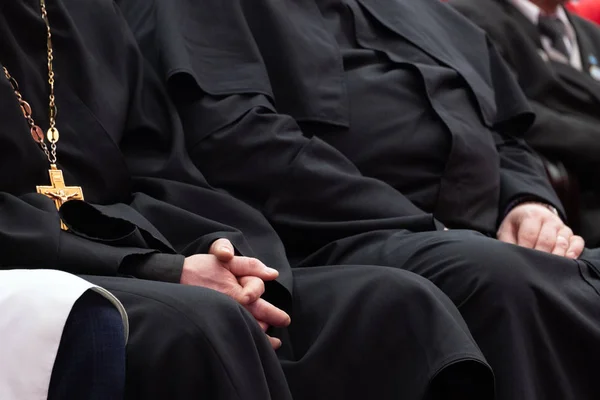 Representatives of the Orthodox clergy in black robes sit in the conference hall. Meeting clerics and priests. Conceptual background for design and news about religion. — Stock Photo, Image
