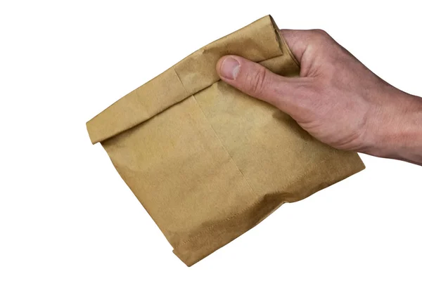 Bruine papieren zak in mannelijke hand. Ecologisch concept. Geïsoleerd op witte achtergrond. — Stockfoto