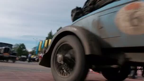 Kazakhstan, Kostanay, 2019-06-20, Rally Peking to Paris. People are watching the movement of a rare racing car. Residents of the city are watching and photographing ret — Stock Video