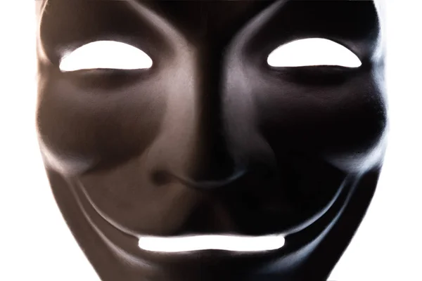 Dark mask isolated on white. Close-up. Smile symbol of an anonymous hacker. Shooting a subject in a dark key. — Stock Photo, Image