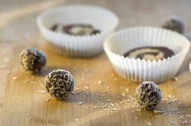 Parti çiğ kahve anad Hindistan cevizi çerezleri kağıt cupcakes ahşap bambu masa, rendelenmiş hindistan cevizi, lezzetli topları