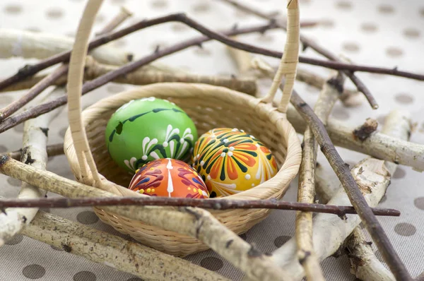 Three Colorful Painted Easter Eggs Brown Wicker Basket Branches Traditional — Stock Photo, Image