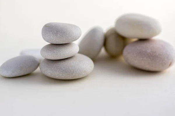 Harmony and balance stack of smooth white pebbles on light background, stone tower