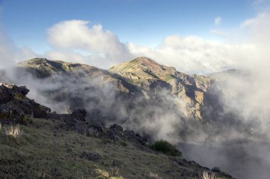 Pico do Arieiro hiking trail, amazing magic landscape with incredible views, rocks and mist clipart