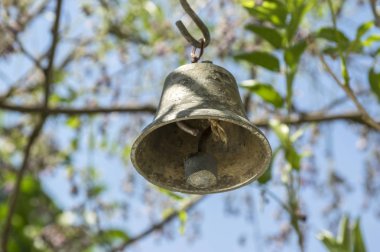 Küçük metalik oryantal çan Bahçe, güneşli gün, yeşil etrafında asılı