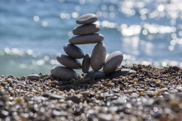 Stones and pebbles stack, harmony and balance, One big pyramid stone cairn on seacoast