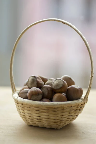Hazelnuts in hard shells, pile in small wicker basket