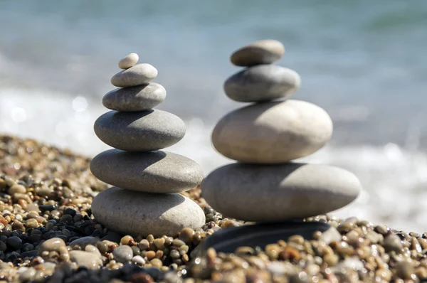 Stones and pebbles stack, harmony and balance, two stone cairns on seacoast