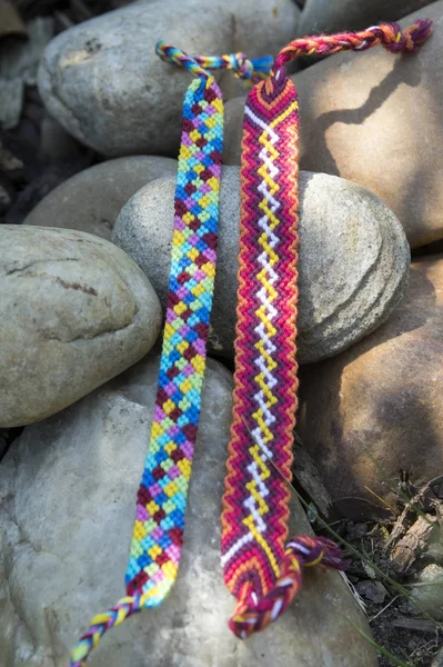 Natural bracelets of friendship in a row, colorful woven friendship bracelets, background, rainbow colors, checkered pattern