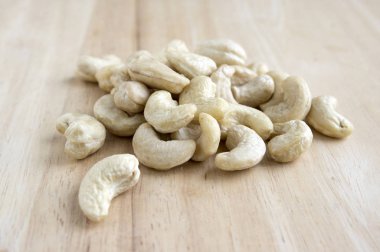 Ahşap masa, basitlik, gün ışığı, sağlıklı fındık üzerinde kahverengi kaju fıstığı döktüm