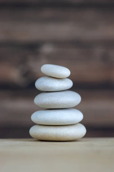 Harmony and balance, cairns, simple poise stones on white background, rock zen sculpture, five white pebbles, single tower, simplicity