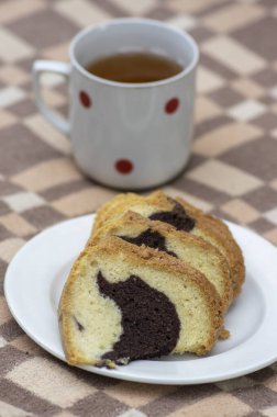 Gugelhupf piknik battaniyesinde beyaz tabak, çok lezzetli iki renkli Çek pastası, adı babovka, yemeye hazır.