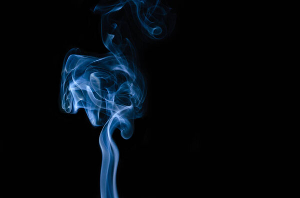 Movement of blue smoke isolated on black background.