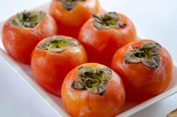 stock image Fresh ripe persimmons isolated on white background,top view.