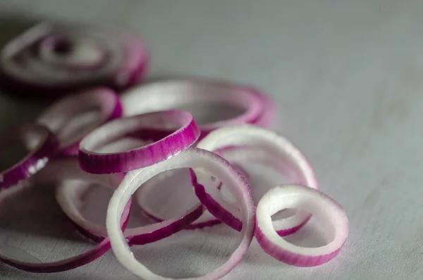 Sliced red onion rings isolated on white background.