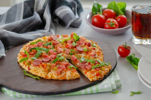 Fatias de pizza com verduras e salame, tomates cereja estão em t — Fotografia de Stock