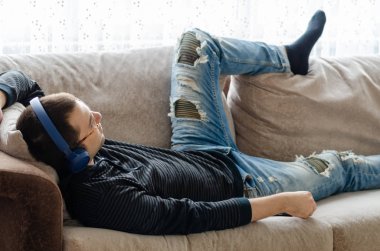 Young man is listening to music at home