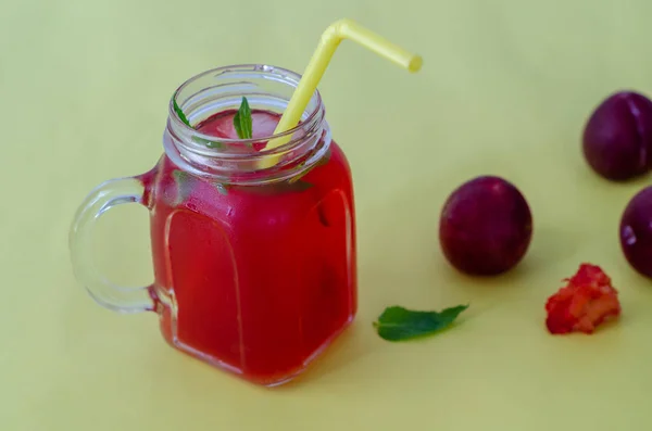 Compote of red plum in a glass jar — Stock Photo, Image