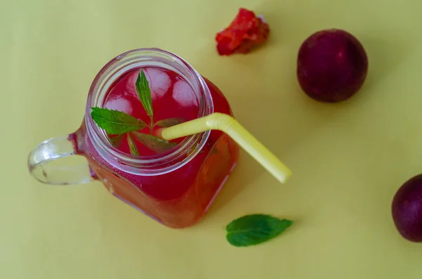 Compote of red plum in a glass jar — Stock Photo, Image