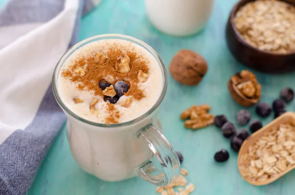 Oatmeal porridge with blueberries and almonds. Healthy breakfast porridge oats on a wooden table. Top view. Healthy eating food.