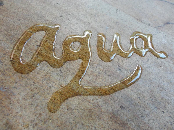 Aqua spontaneous water handwriting calligraphy. Artistic and natural photo good use for any design you want.