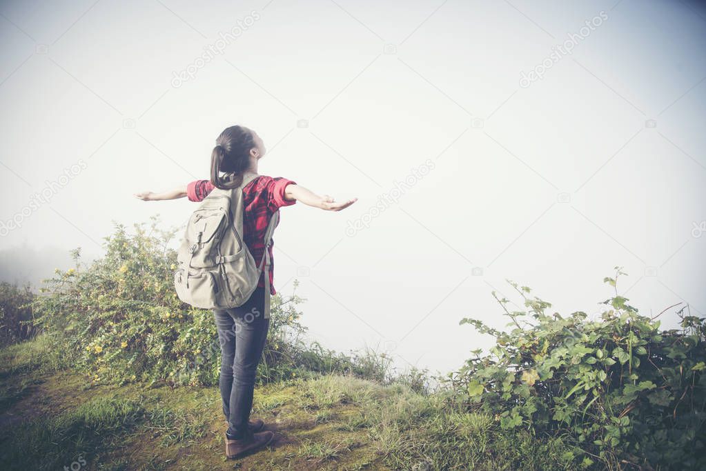 Happy hiker with her arms outstretched, freedom and happiness, a