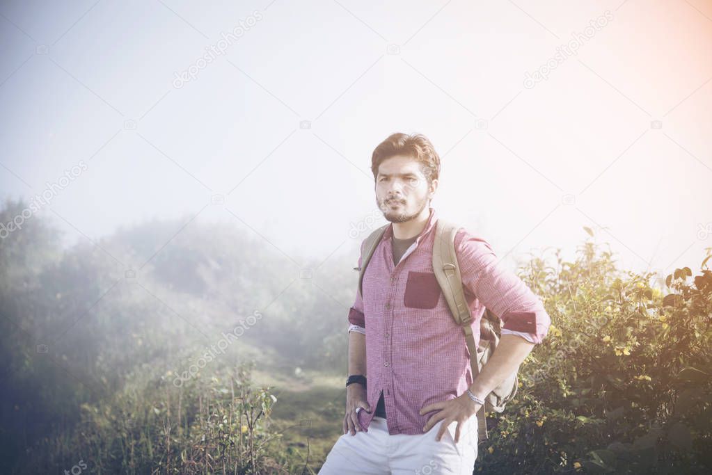 young male backpacker enjoy the view at mountain peak