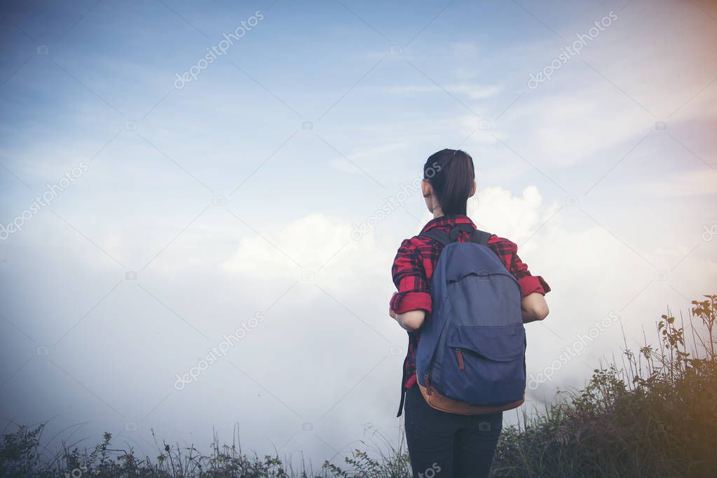 Freedom traveler woman standing with raised arms and enjoying a 