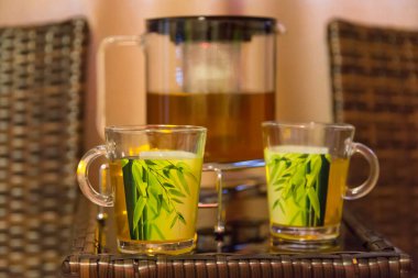 Kaplıcadaki ahşap masada naneli bir fincan çay.