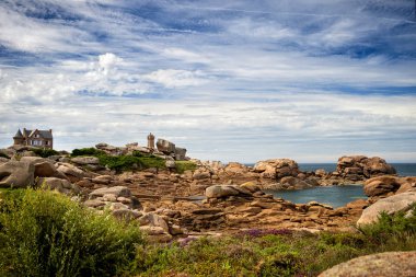 Ploumanac'h Mean Ruz lighthouse between the rocks in pink granite coast, Perros Guirec, Brittany, France. clipart