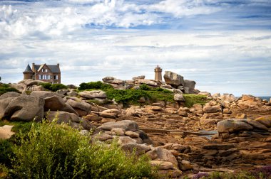 Ploumanac 'h Mean Ruz deniz feneri Pembe granit sahilindeki kayaların arasında, Perros Guirec, Brittany, Fransa.