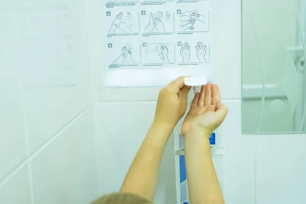 The child disinfects his hands in the toilet.Coronavirus. — Stock Photo, Image