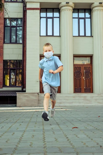 schoolboy running away from school. High quality photo