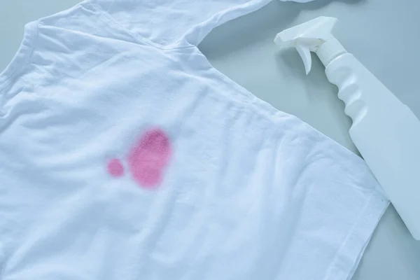 dirty pink stain on clothes. The concept of cleaning stains on clothes. Means of cleaning stains. . High quality photo