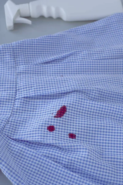 dirty blood stains on dress and stain remover.isolated on gray background. High quality photo