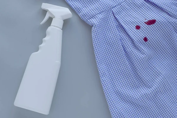 dirty blood stains on dress and stain remover.isolated on gray background. High quality photo