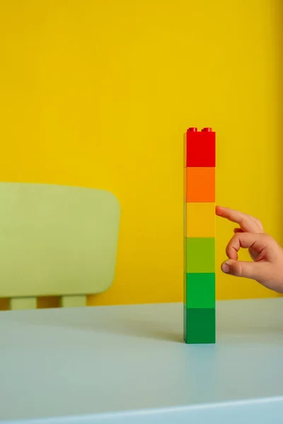 Tower of colored blocks.on a yellow background