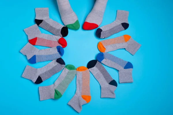 Colored socks in a around on a blue background — Stock Photo, Image