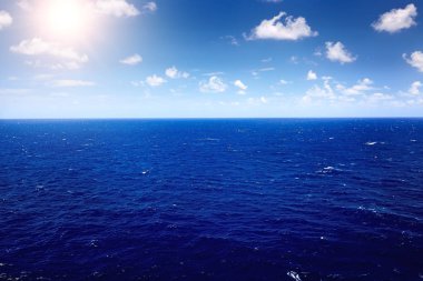 Mavi gökyüzü ve bulutlu derin mavi deniz