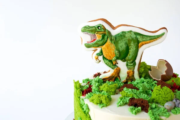 Cake with dinosaur and green leaves. Gift for the boy. Picture for a menu or a confectionery catalog.