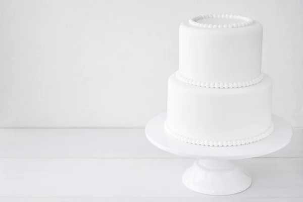 White wedding cake blank on a white background. Simple minimalism.