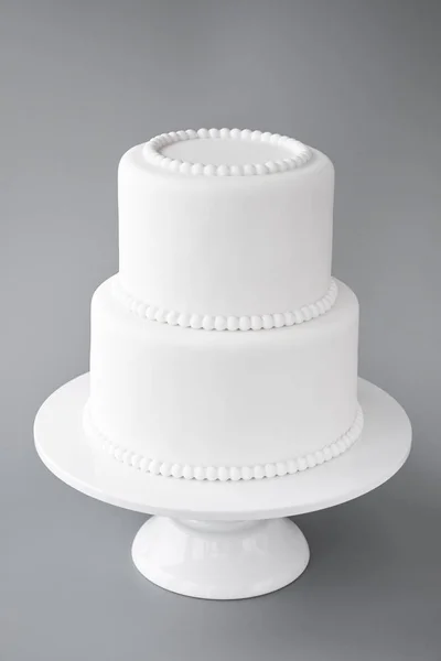White wedding cake blank on a gray background. Simple minimalism.