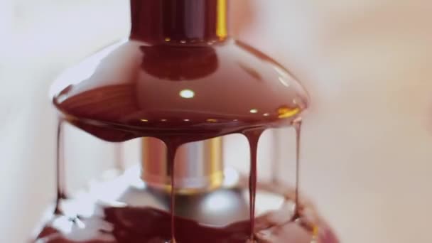 Chocolate drips down in a chocolate fountain — Stock Video