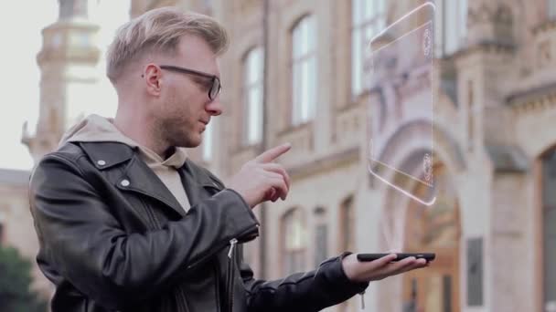 Smart young man with glasses shows a conceptual hologram large passenger aircraft — Stock Video
