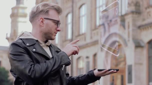 Jeune homme intelligent avec des lunettes montre un hologramme conceptuel sûr avec de l'argent — Video